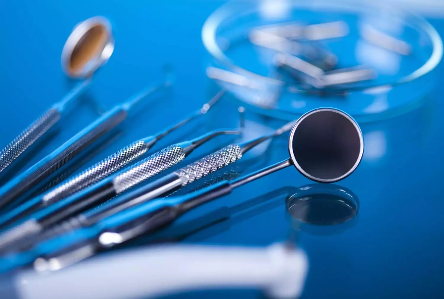 Close-up of essential dental implant surgical tools, including dental drills, implant drivers, torque wrenches, abutments, and implant surgical guides, arranged in a sterile setup, prepared for precision-guided dental implant placement and osseointegration procedures.